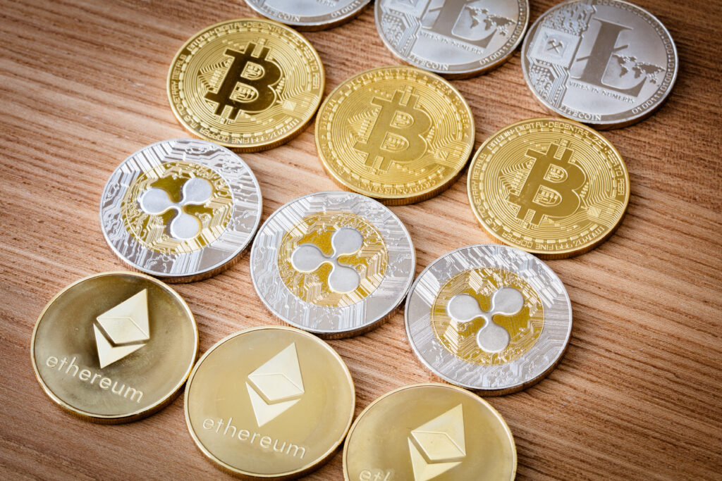 Grupa monet kryptowalutowych, w tym Bitcoin, Litecoin, Ripple i Ethereum na odizolowanym tle.